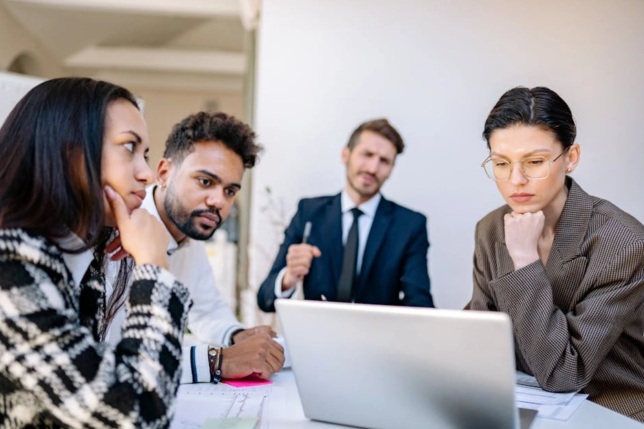 The diverse and professional team of Nexus Growth Advisors collaborating in a bright, modern office.